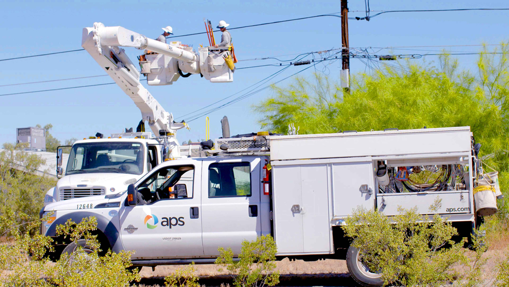 APS truck in the field below power lines