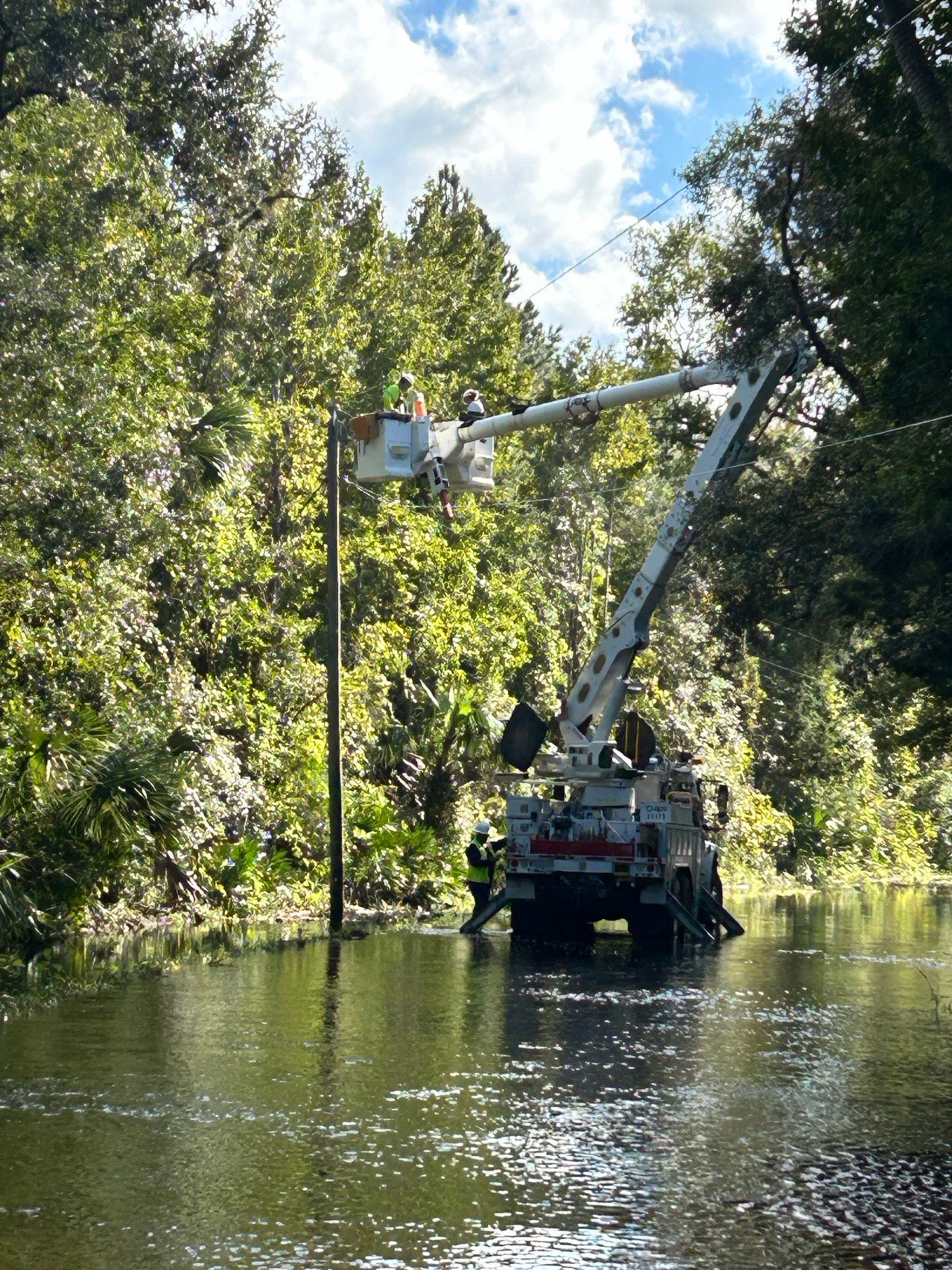 APS workers repair a pole in Florida