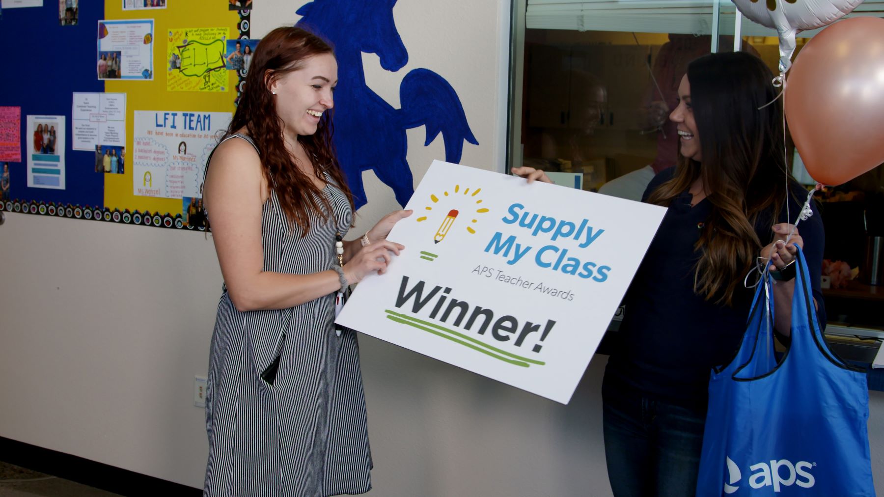 A Supply My Class grant winner gets a giant check