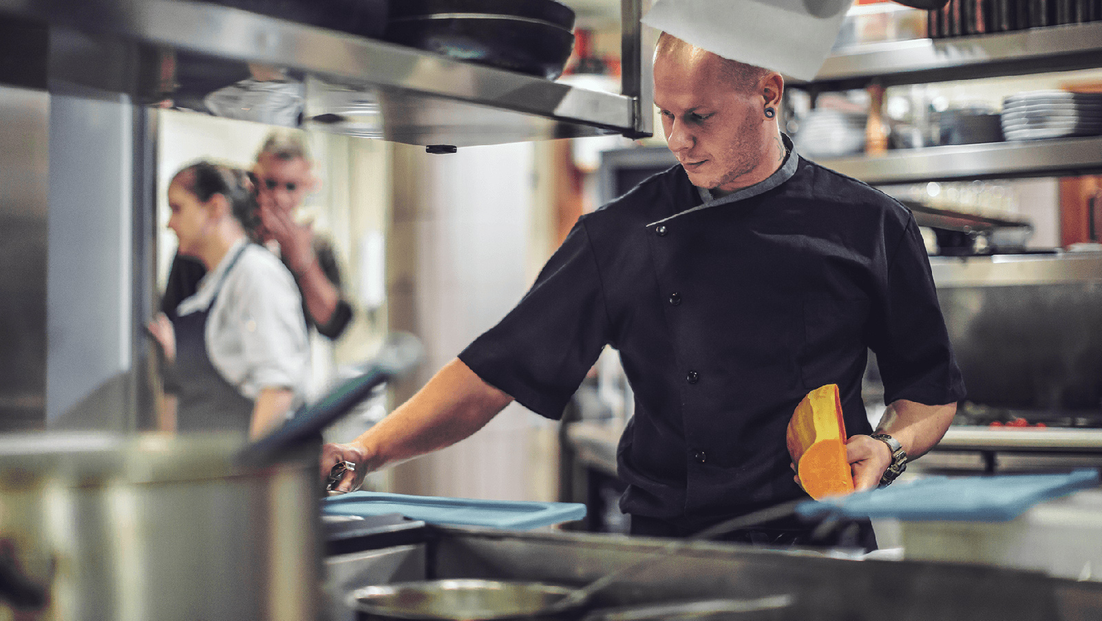 Chef making food in a restaurant kitchen.