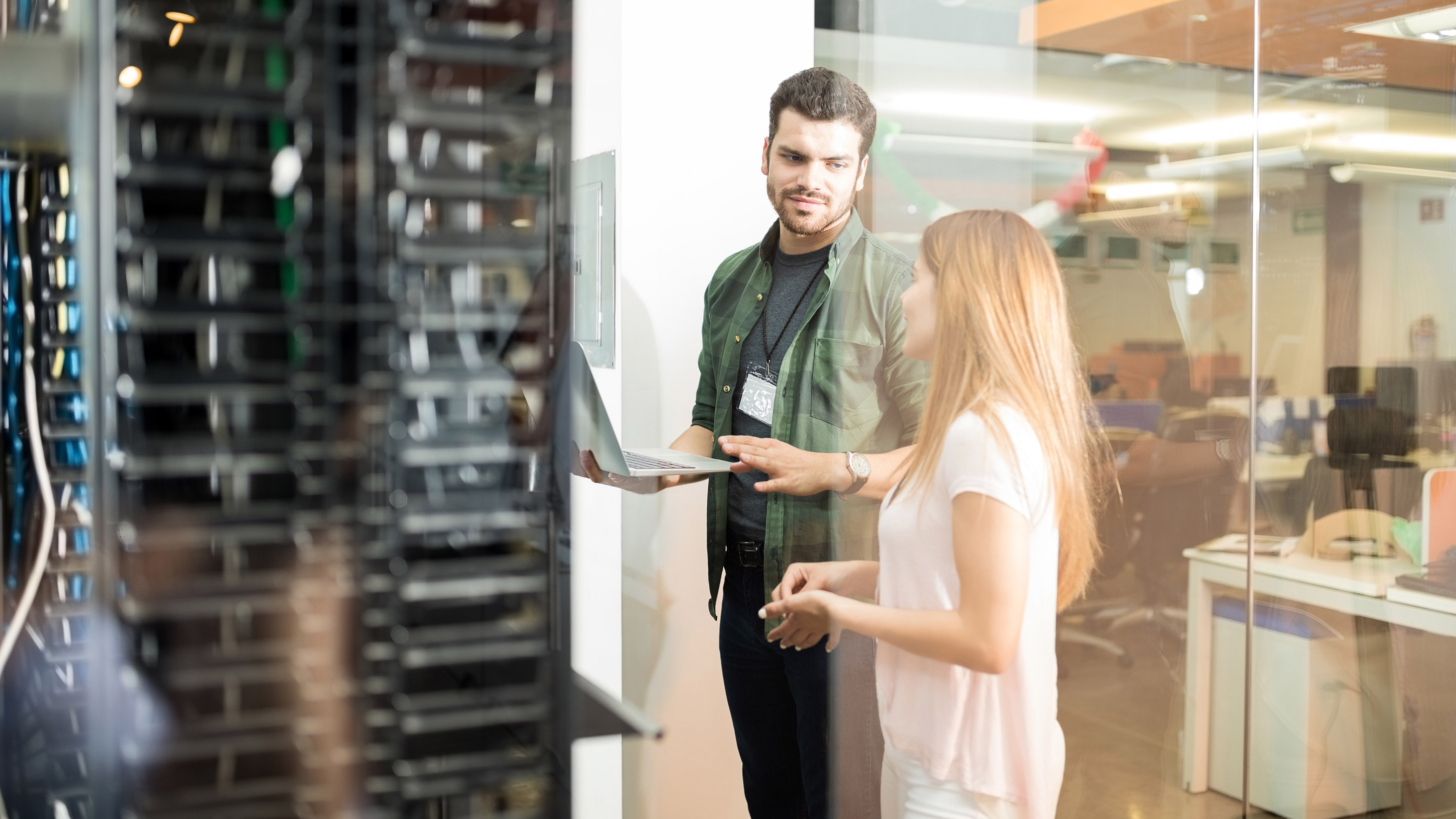 Two young professionals using the computer