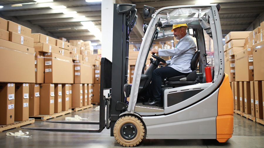 Man in warehouse operating a forklift