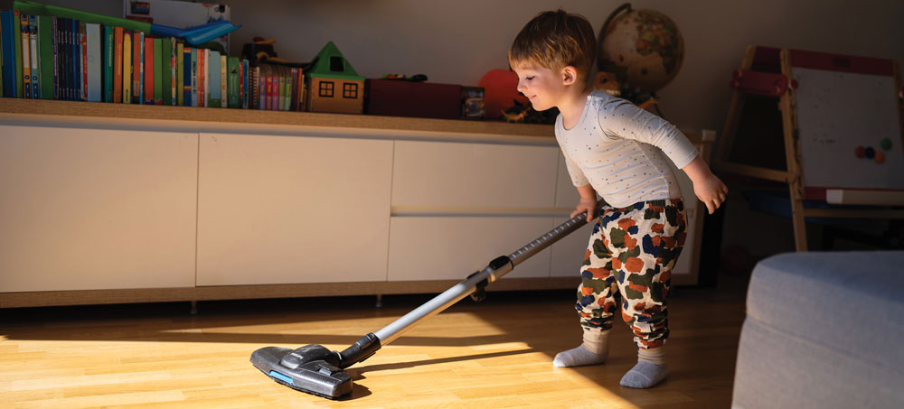 Child playing with a vacuum