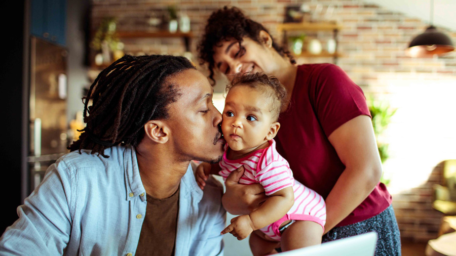 Dad kissing his baby's cheek