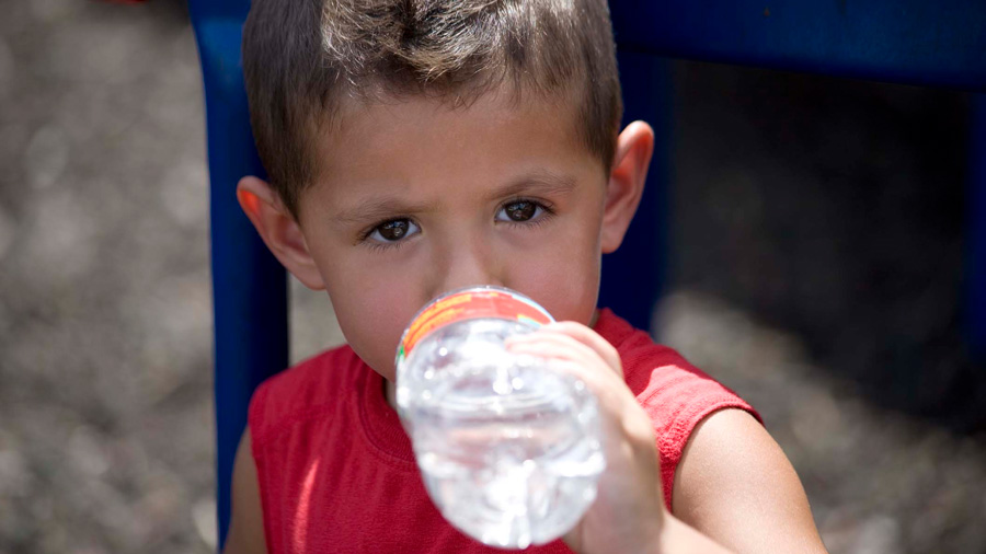 Little boy drinking a water bottle