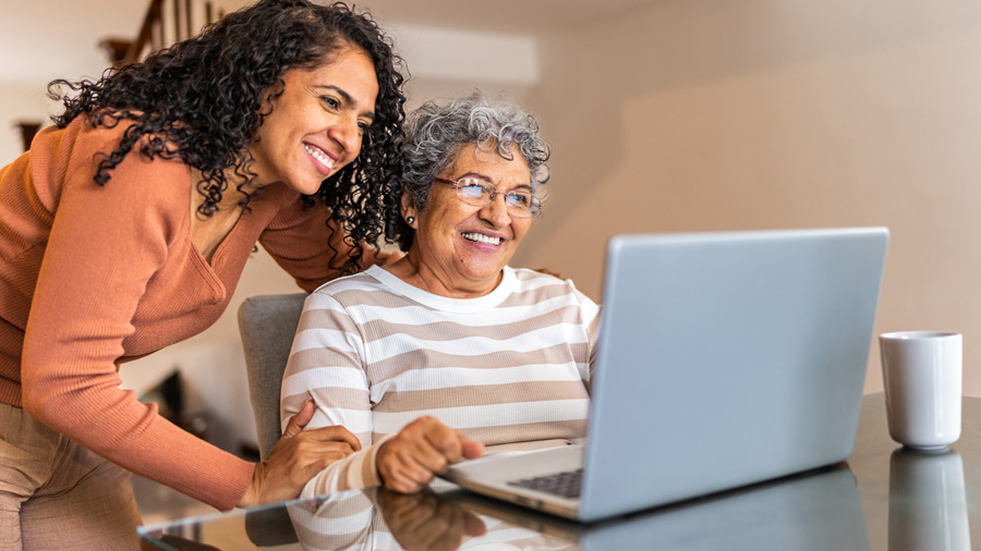 Woman helping her mom with her laptop