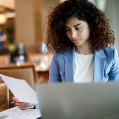 Young woman paying bills on a laptop